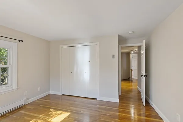 a view of a room with wooden floor and bathroom