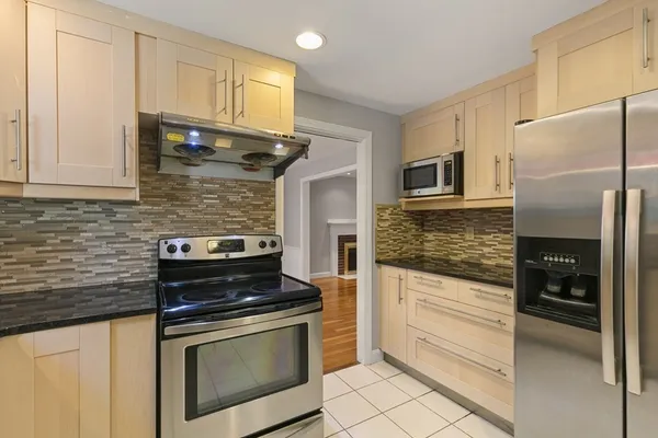 a kitchen with stainless steel appliances granite countertop a stove and a refrigerator