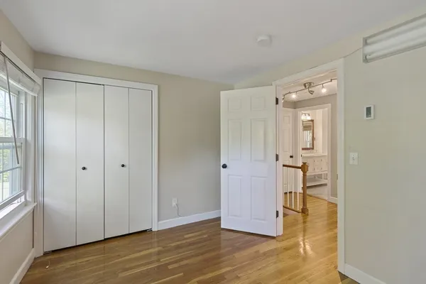 a view of a room with wooden floor staircase and bathroom