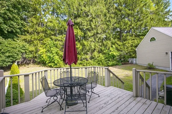 a view of a deck with furniture and wooden deck