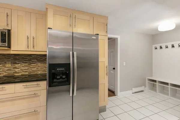 a kitchen with granite countertop a refrigerator and a stove