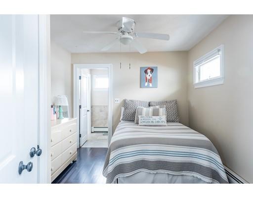 140 Fort Point Road Weymouth, MA 02191 - Photo 20 of 24 a spacious bedroom with a bed and a chandelier