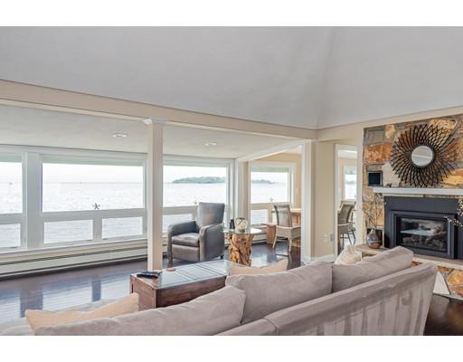 140 Fort Point Road Weymouth, MA 02191 - Photo 5 of 24 a living room with furniture a fireplace and floor to ceiling windows