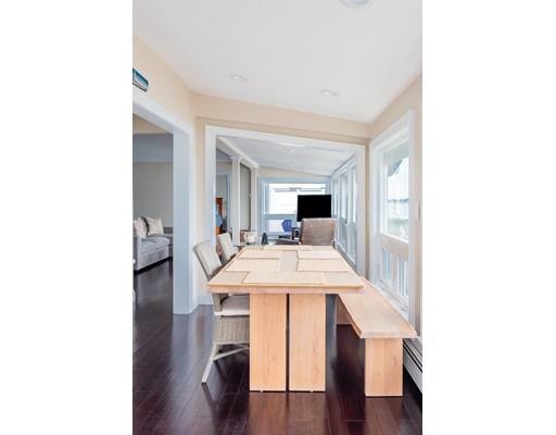 140 Fort Point Road Weymouth, MA 02191 - Photo 9 of 24 a living room with stainless steel appliances kitchen island a table and chairs