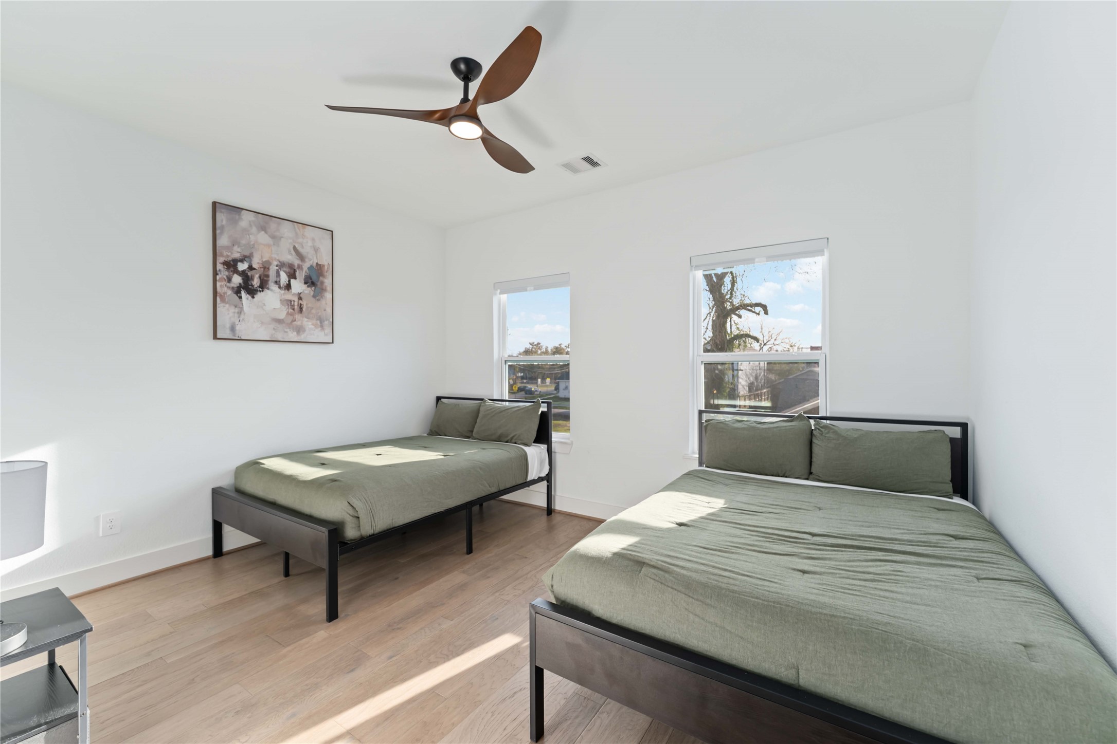 3034 Gray Street, Unit B Houston, TX 77004 - Photo 16 of 23 a bedroom with furniture and a wooden floor