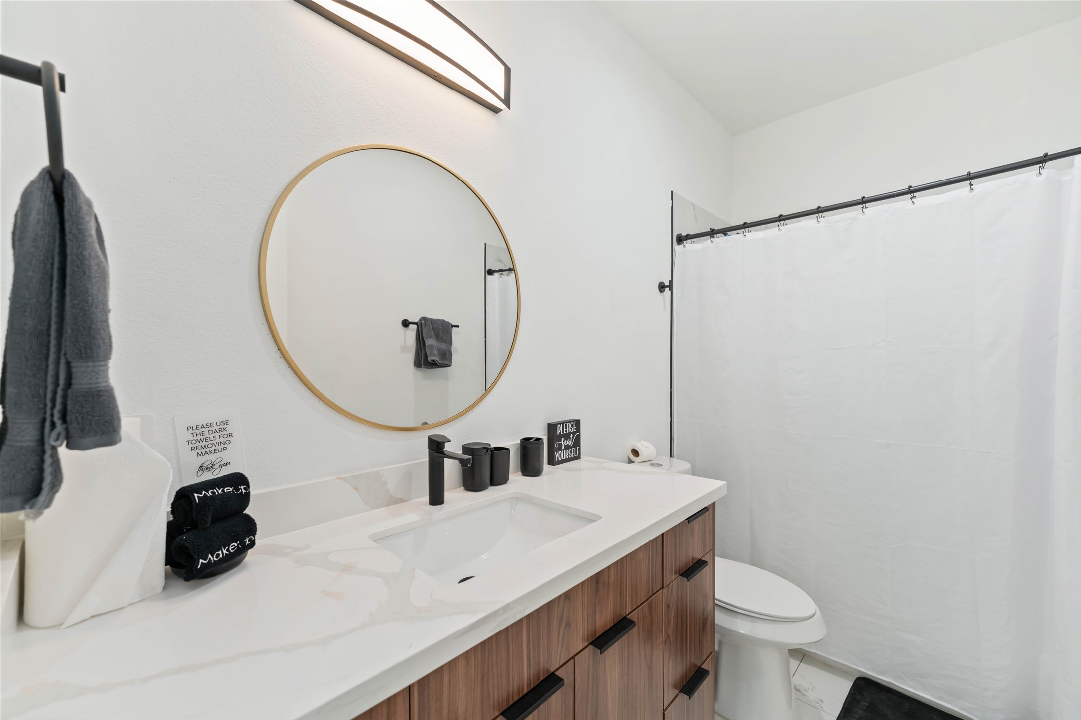 3034 Gray Street, Unit B Houston, TX 77004 - Photo 20 of 23 a bathroom with a sink mirror and toilet