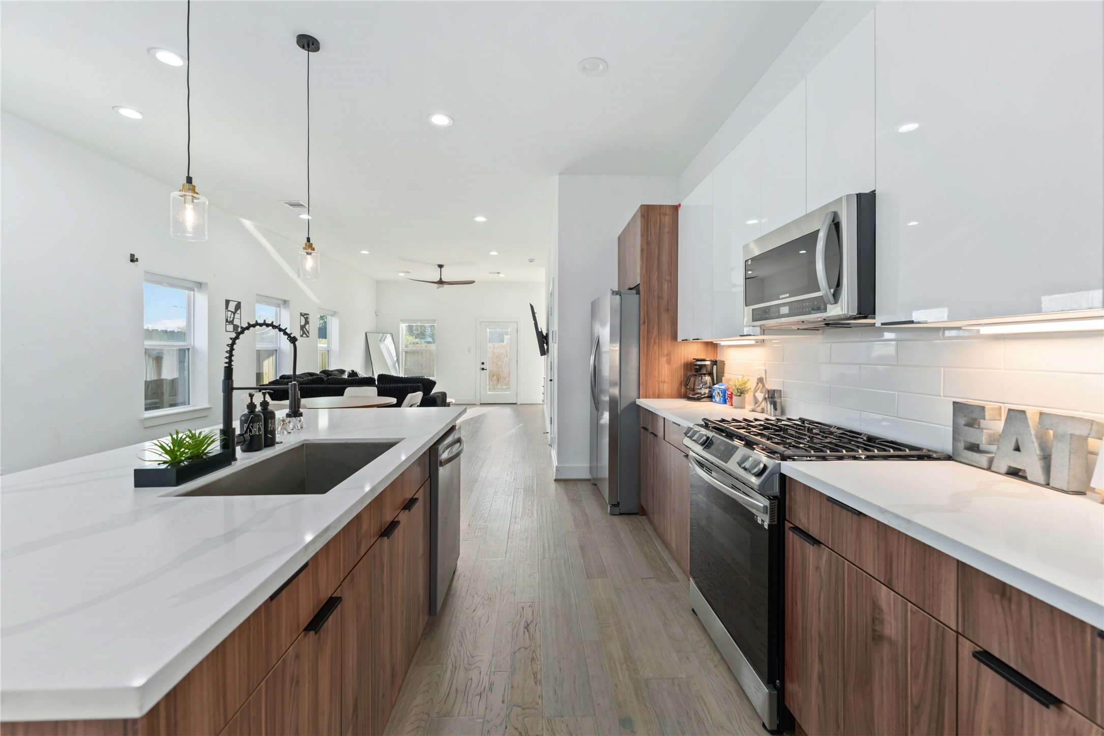 3034 Gray Street, Unit B Houston, TX 77004 - Photo 4 of 23 a kitchen with stainless steel appliances granite countertop sink stove top oven and refrigerator