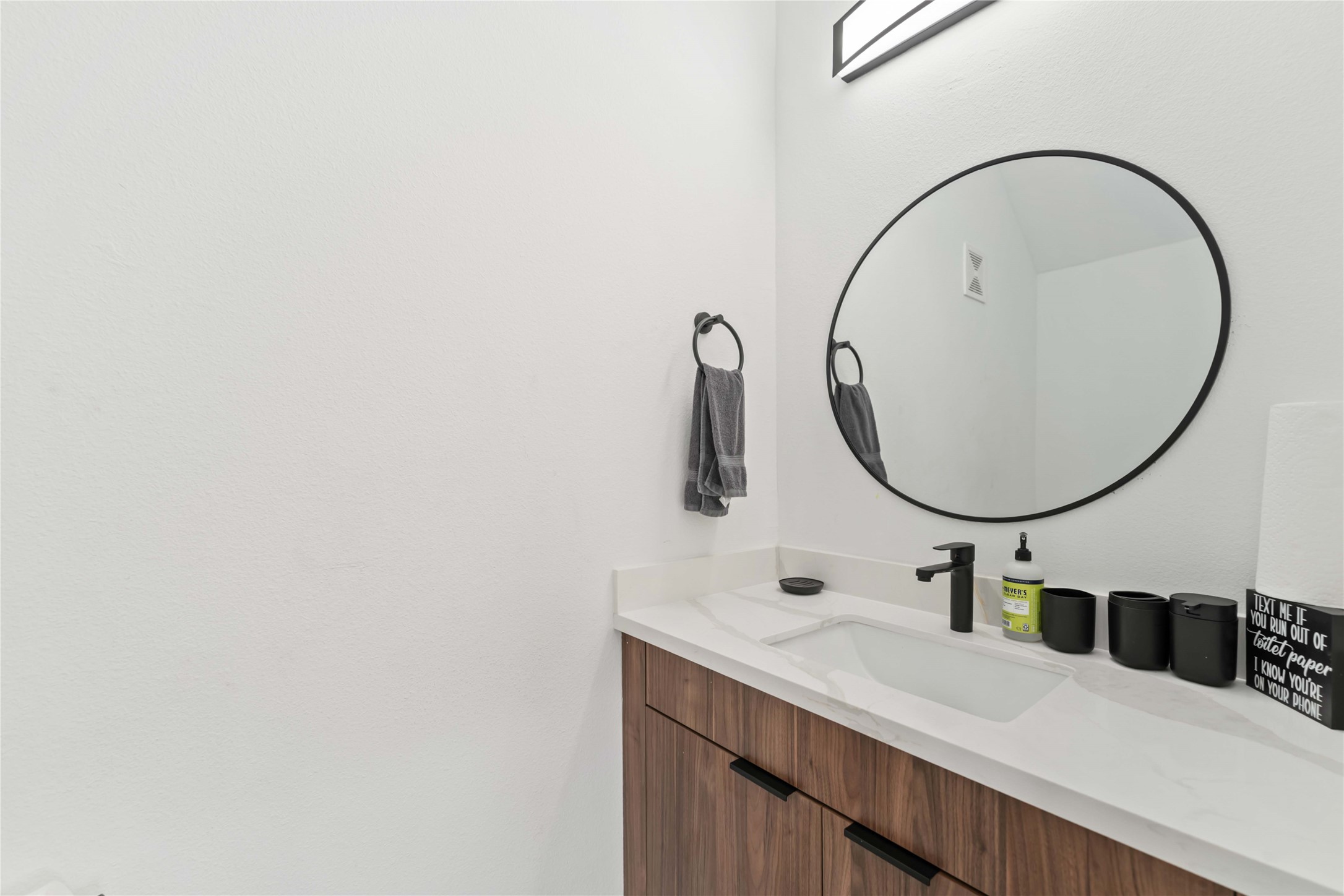 3034 Gray Street, Unit B Houston, TX 77004 - Photo 9 of 23 a bathroom with a sink and a mirror