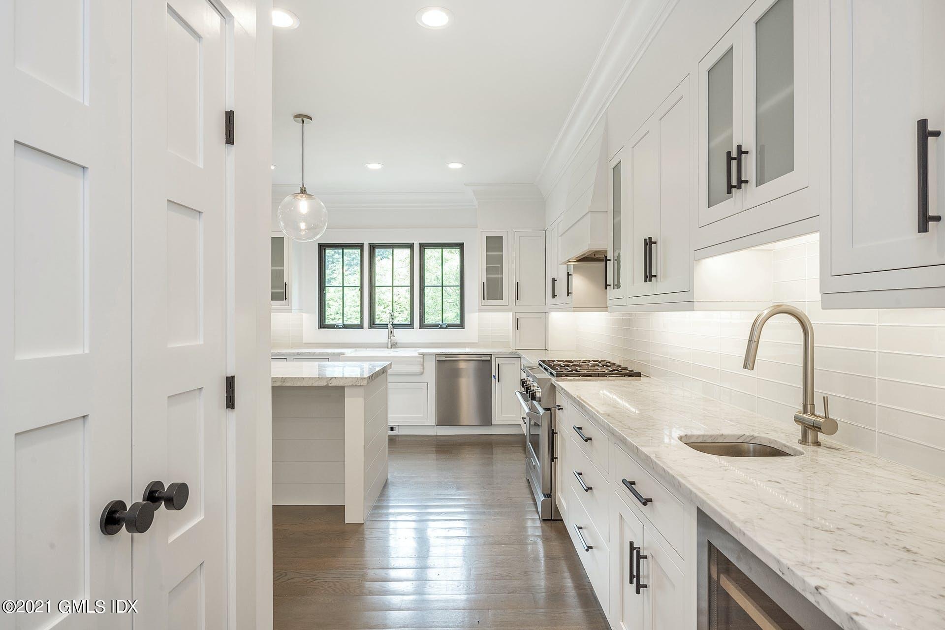 22 Wescott Street Riverside, CT 06878 - Photo 11 of 37 a kitchen with granite countertop a sink stove and cabinets