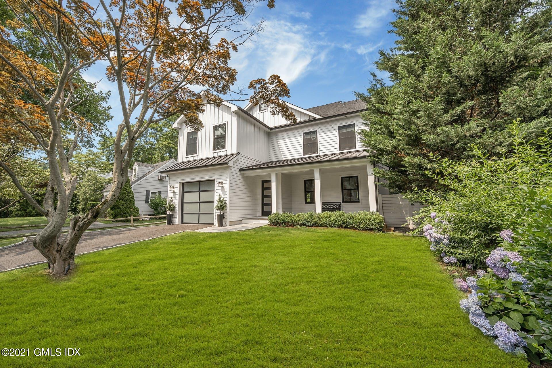 22 Wescott Street Riverside, CT 06878 - Photo 2 of 37 a front view of a house with a garden