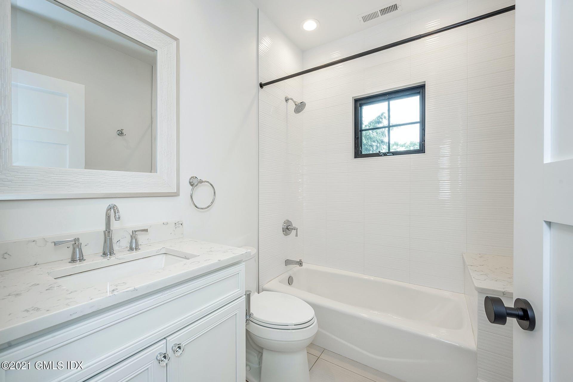 22 Wescott Street Riverside, CT 06878 - Photo 23 of 37 a bathroom with a granite countertop sink a toilet a mirror and shower