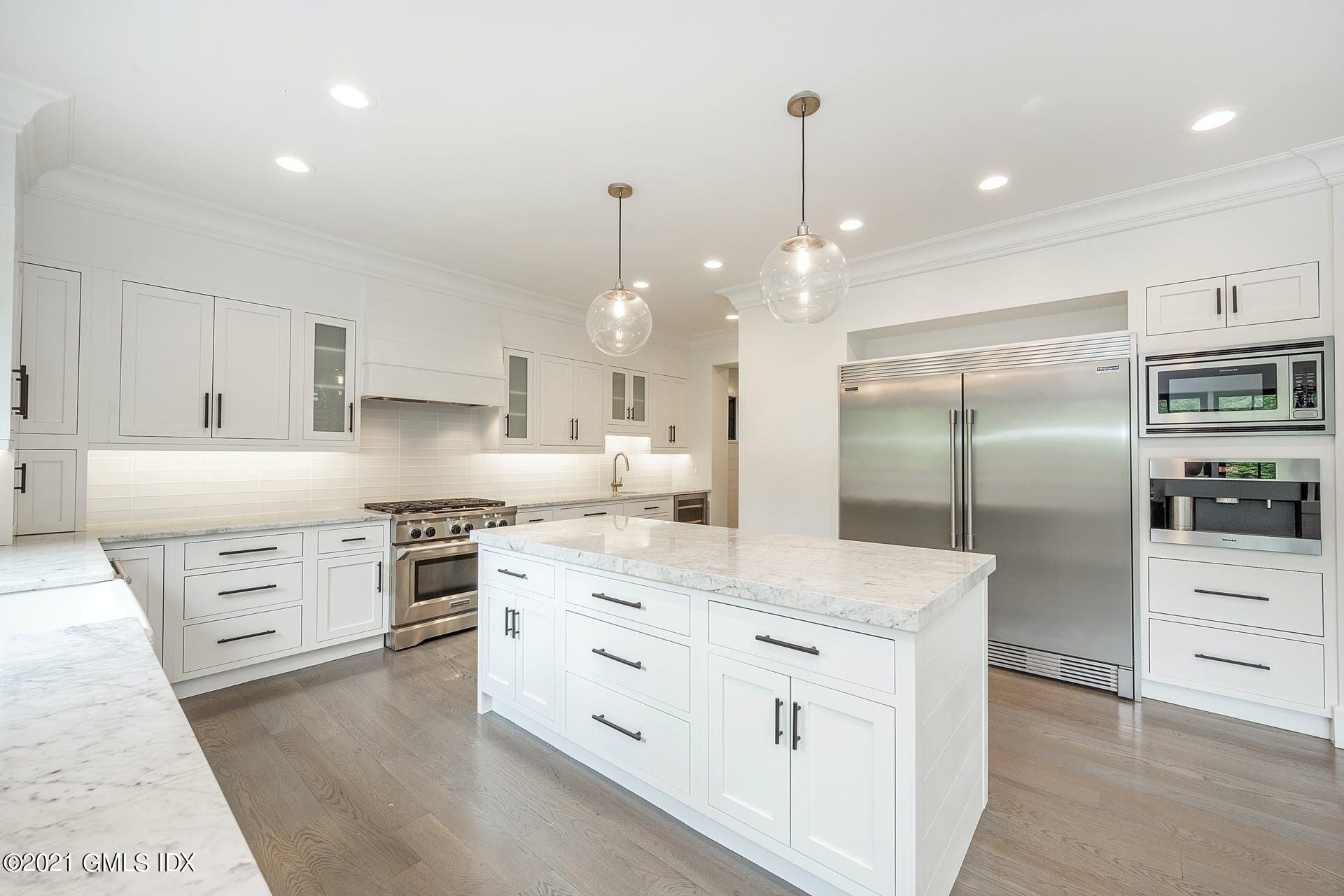 22 Wescott Street Riverside, CT 06878 - Photo 8 of 37 a kitchen with stainless steel appliances kitchen island granite countertop a stove a sink and a refrigerator