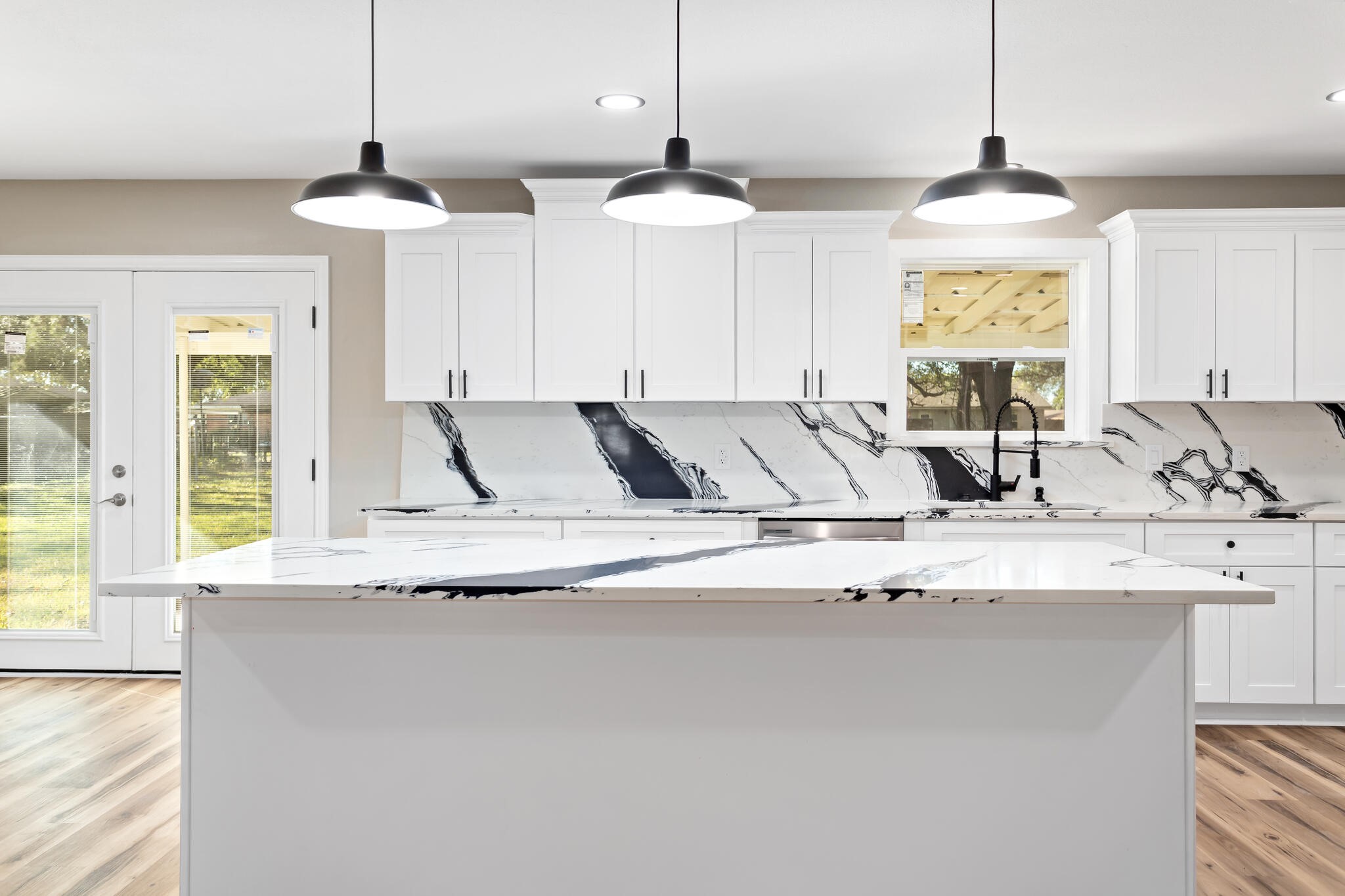 a view of a kitchen with granite countertop a stove a sink and a window