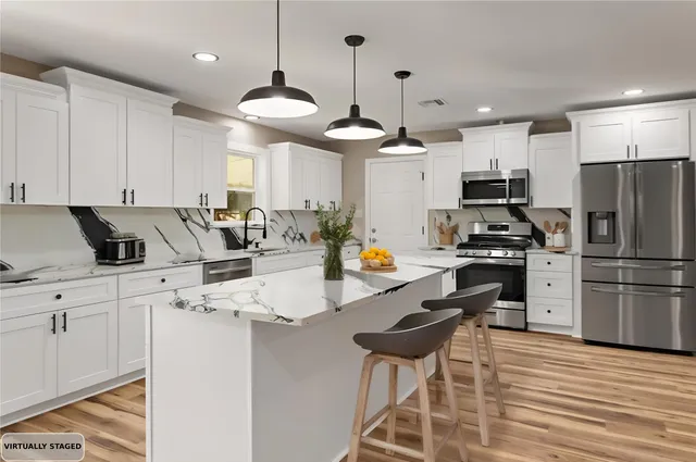 a view of a kitchen with granite countertop a stove a sink and a window