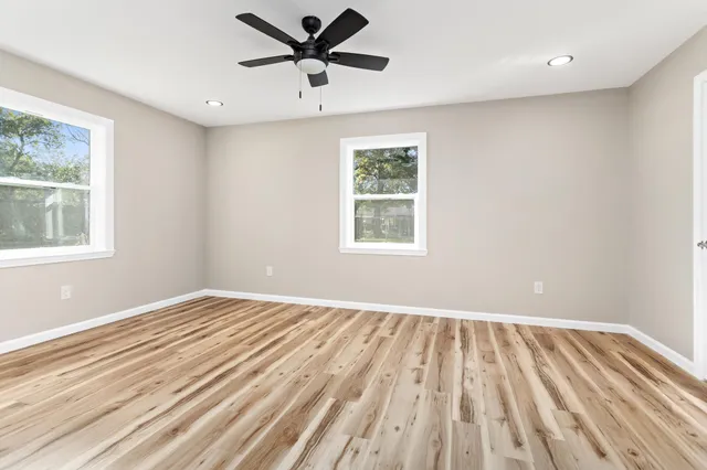 wooden floor in an empty room with a window
