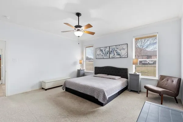 a bedroom with a bed couch and a window