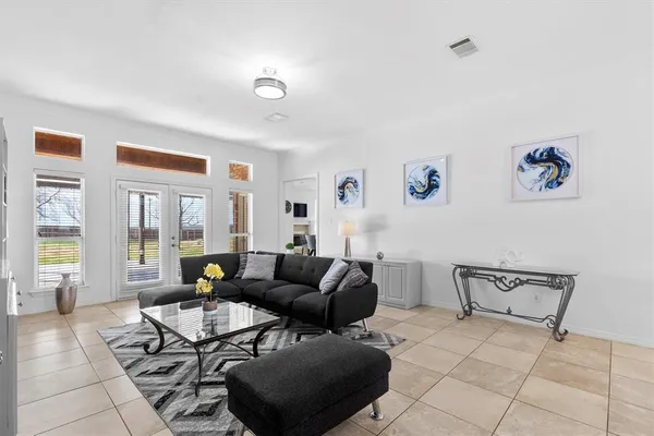 a living room with furniture and floor to ceiling windows