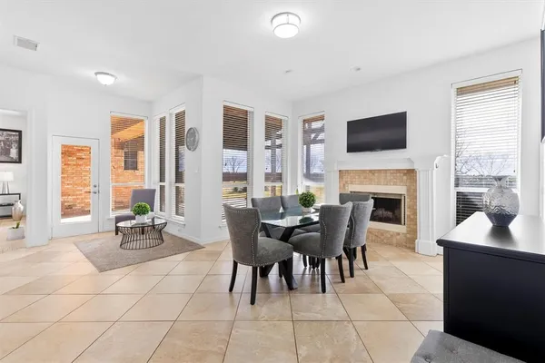 a dining room with furniture a fireplace and wooden floor