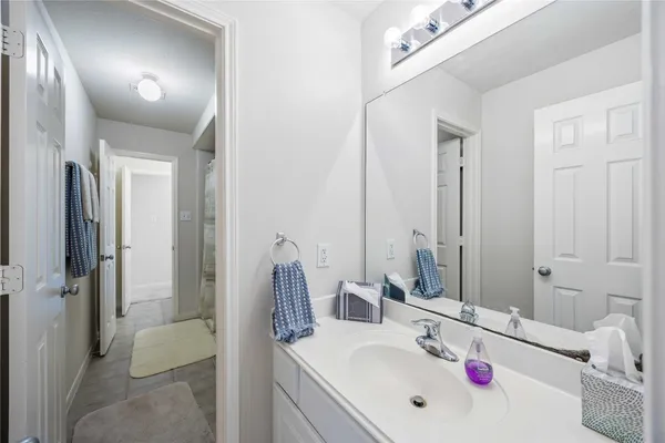 a bathroom with a sink vanity tub and shower