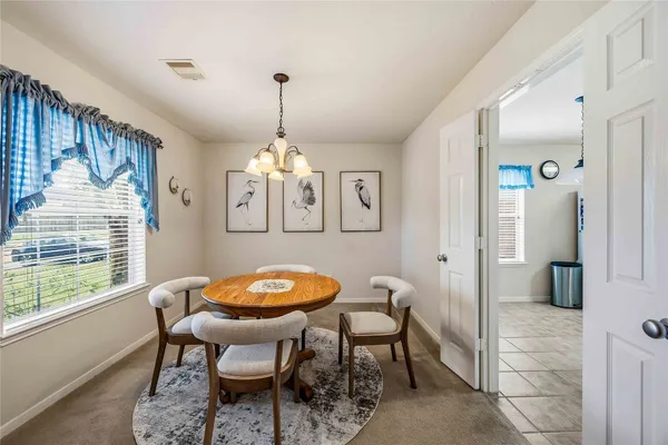 a view of a dining room with furniture window and outside view