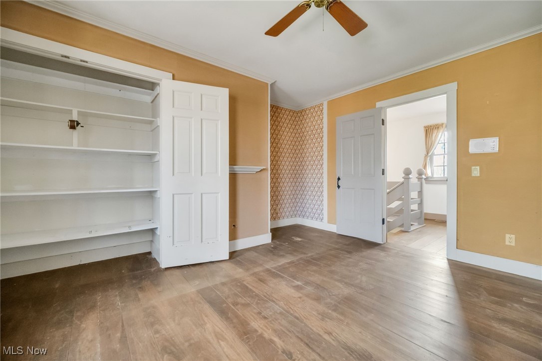 18060 Falling Leaves Road Strongsville, OH 44136 - Photo 27 of 43 Unfurnished bedroom featuring baseboards, ornamental molding, and hardwood / wood-style floors