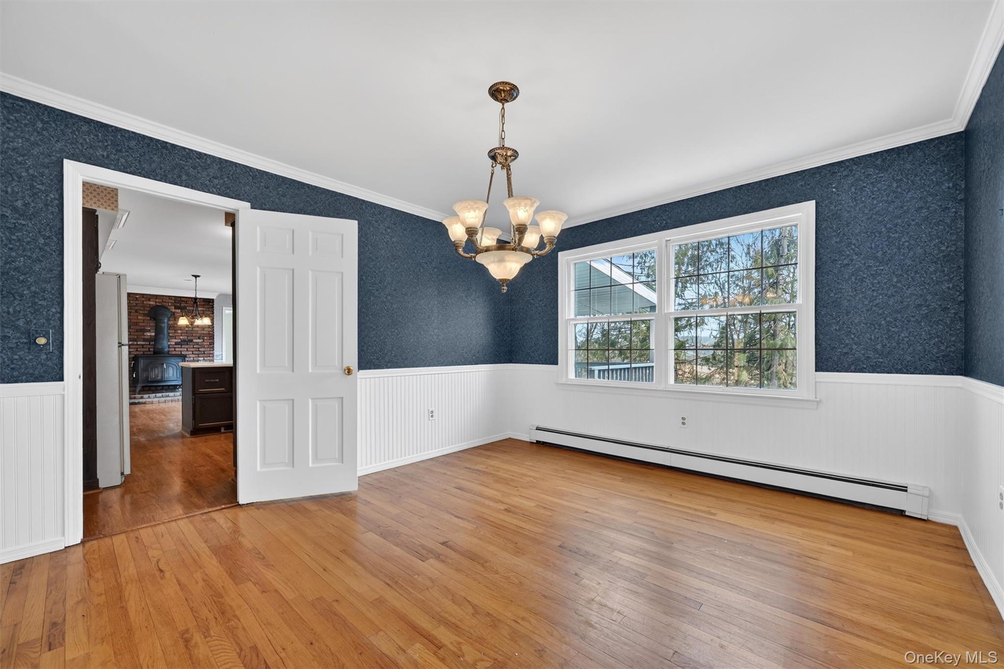 47 Still Road Westtown, NY 10998 - Photo 11 of 49 This room is bright with natural light and features hardwood floors, chair rail, wainscoting, and crown moulding.