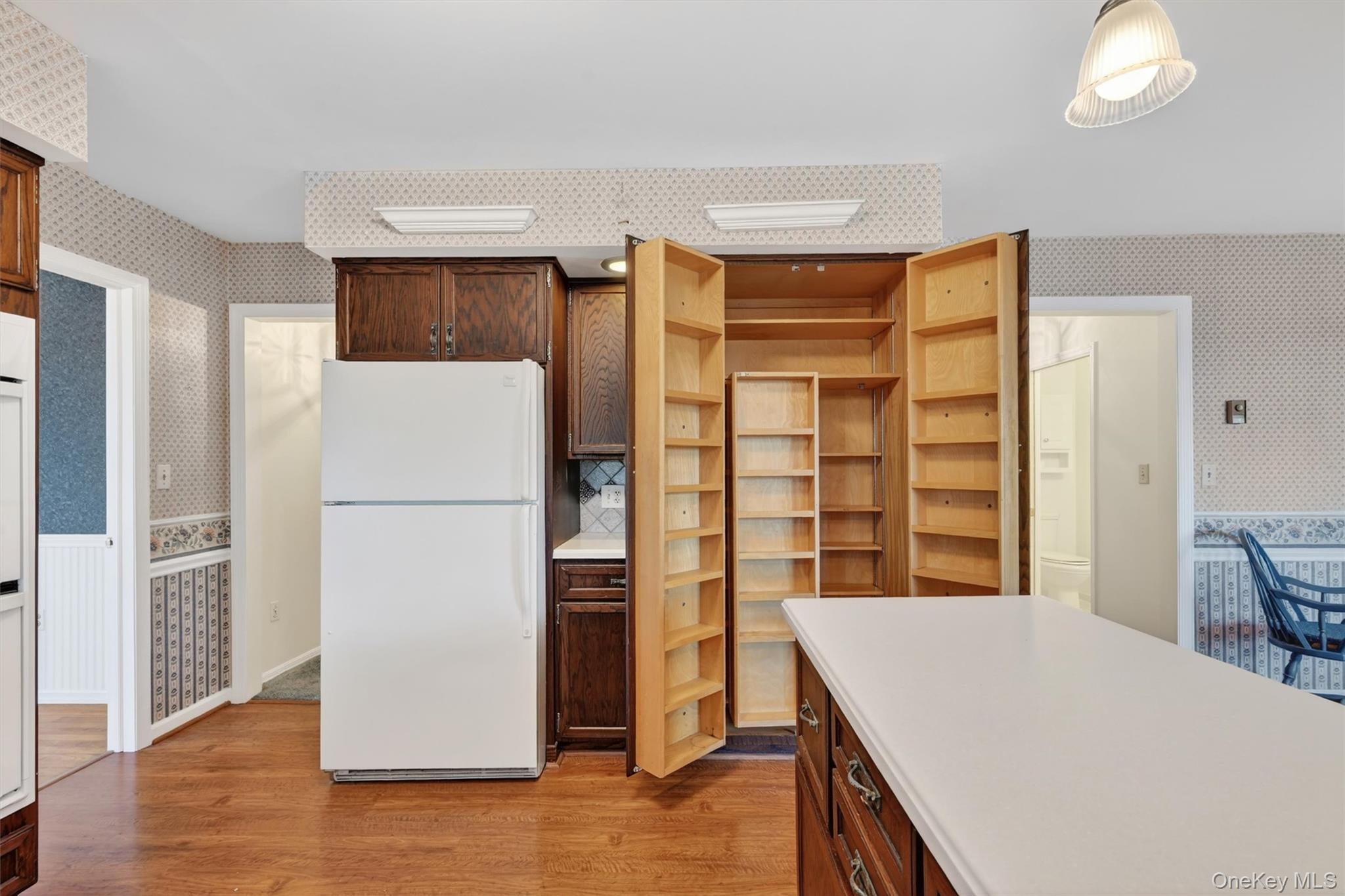 47 Still Road Westtown, NY 10998 - Photo 19 of 49 Kitchen featuring a white refrigerator, wood cabinets, and a pantry with wooden shelving.
