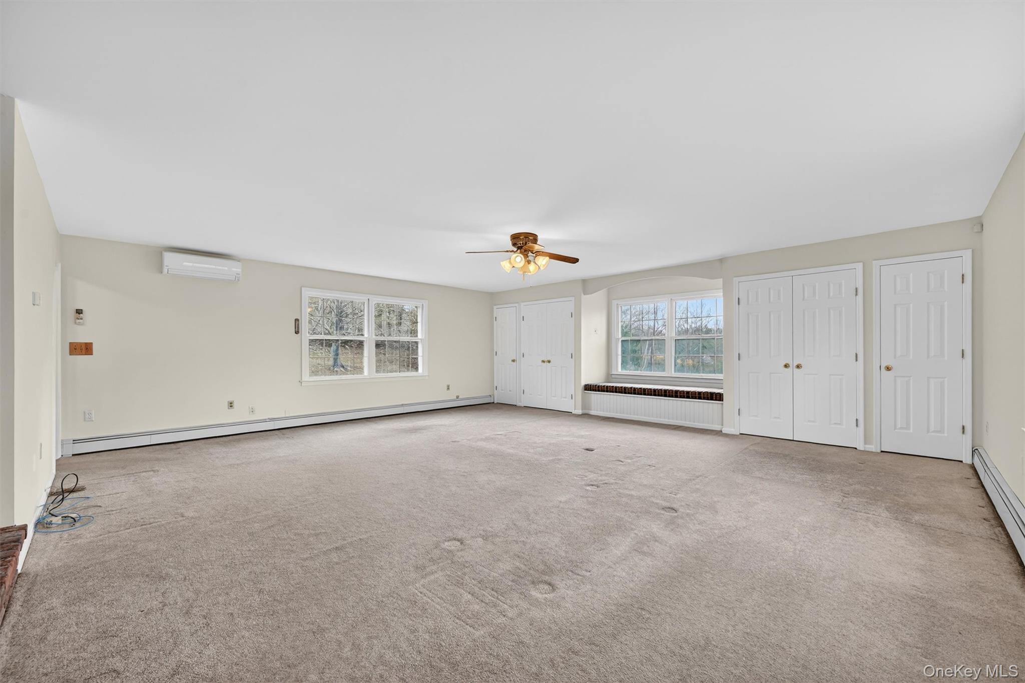 47 Still Road Westtown, NY 10998 - Photo 23 of 49 This expansive family room features light-colored walls, carpeted flooring, and a delightful window seat with built-in storage.
