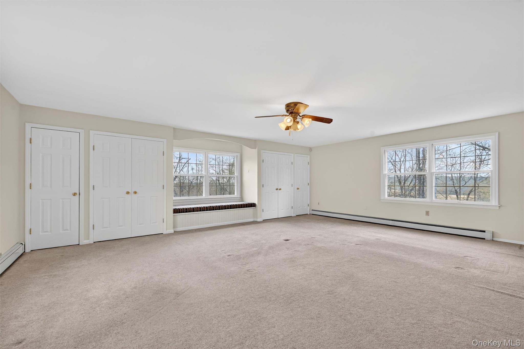 47 Still Road Westtown, NY 10998 - Photo 24 of 49 This spacious room features neutral carpeting, a ceiling fan with lighting, and multiple windows providing natural light and exterior views