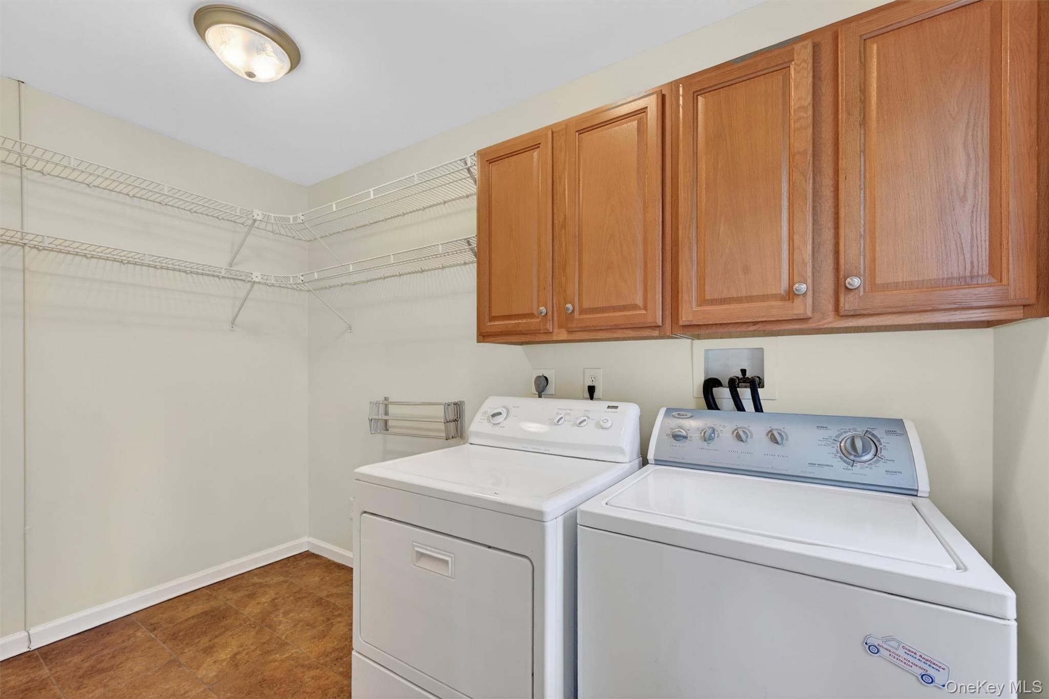 47 Still Road Westtown, NY 10998 - Photo 25 of 49 Laundry area featuring overhead cabinetry and wire shelving.