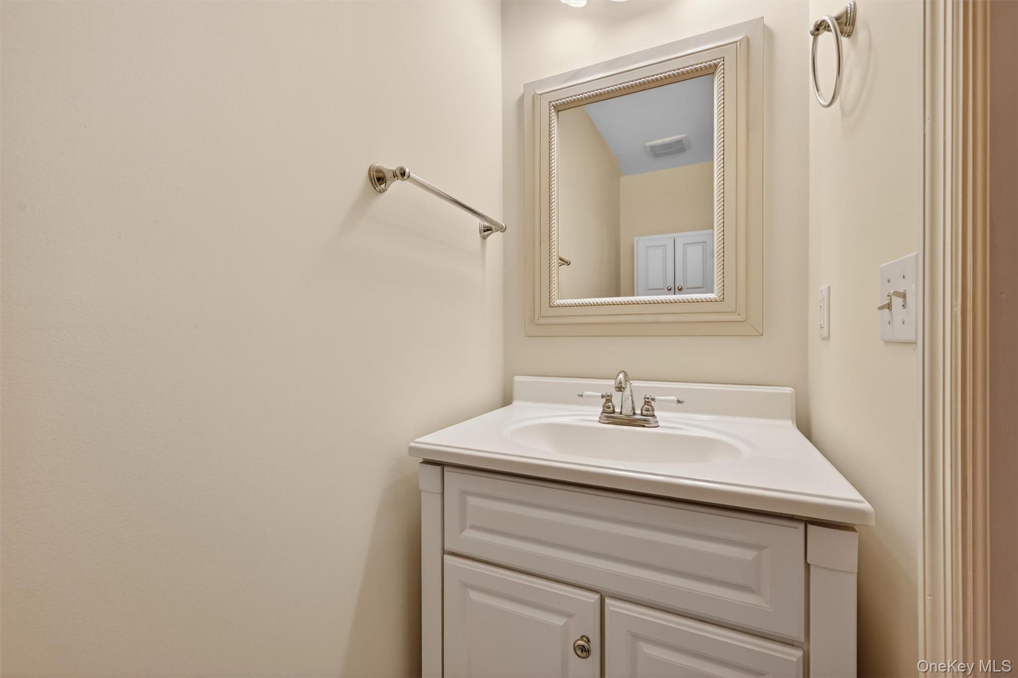 47 Still Road Westtown, NY 10998 - Photo 26 of 49 View of half bathroom located on the main level. The vanity features a white countertop and an integrated sink with a chrome faucet.