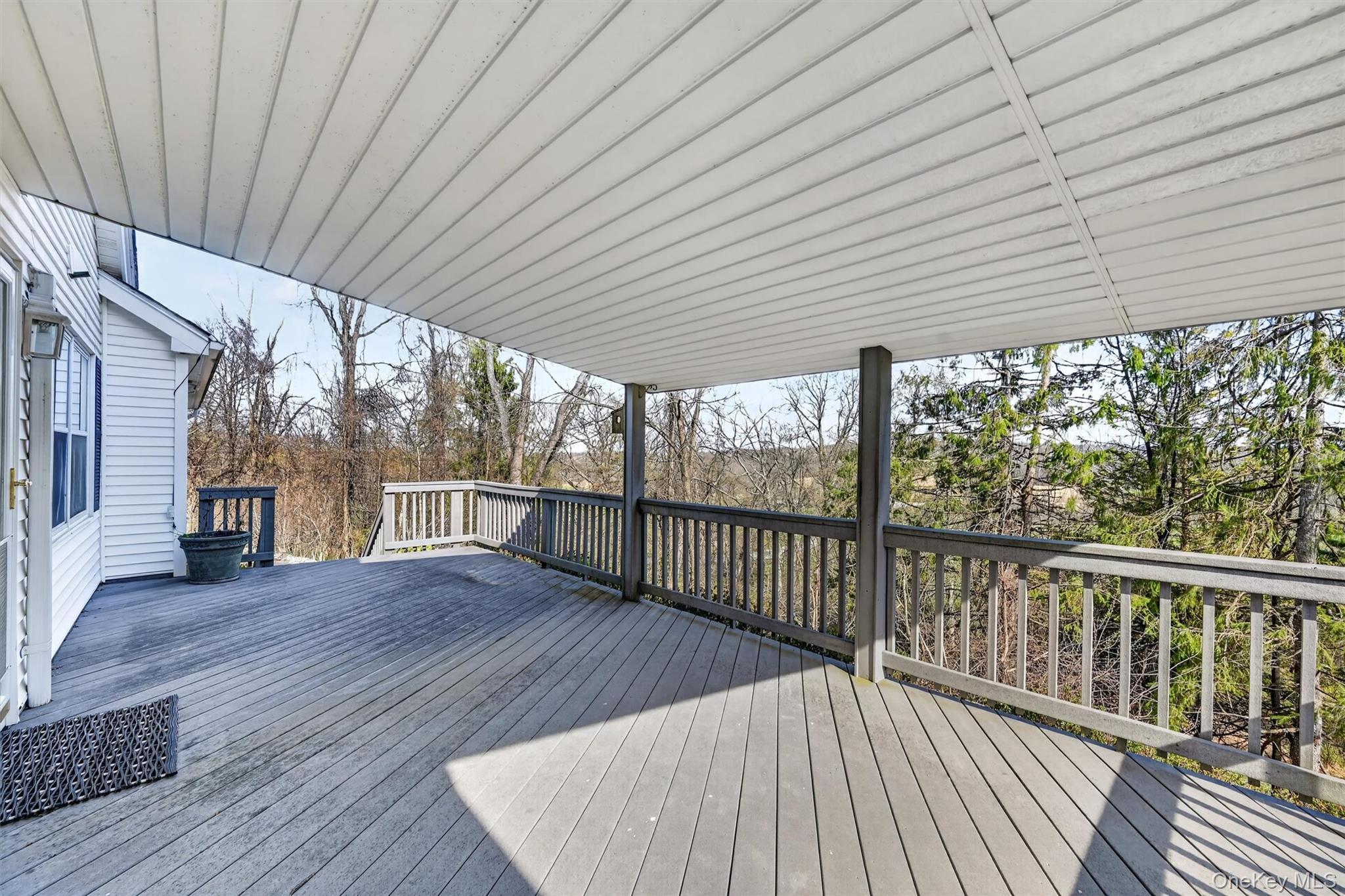47 Still Road Westtown, NY 10998 - Photo 39 of 49 Partially covered composite deck off back of the home offers shaded space with sweeping views.