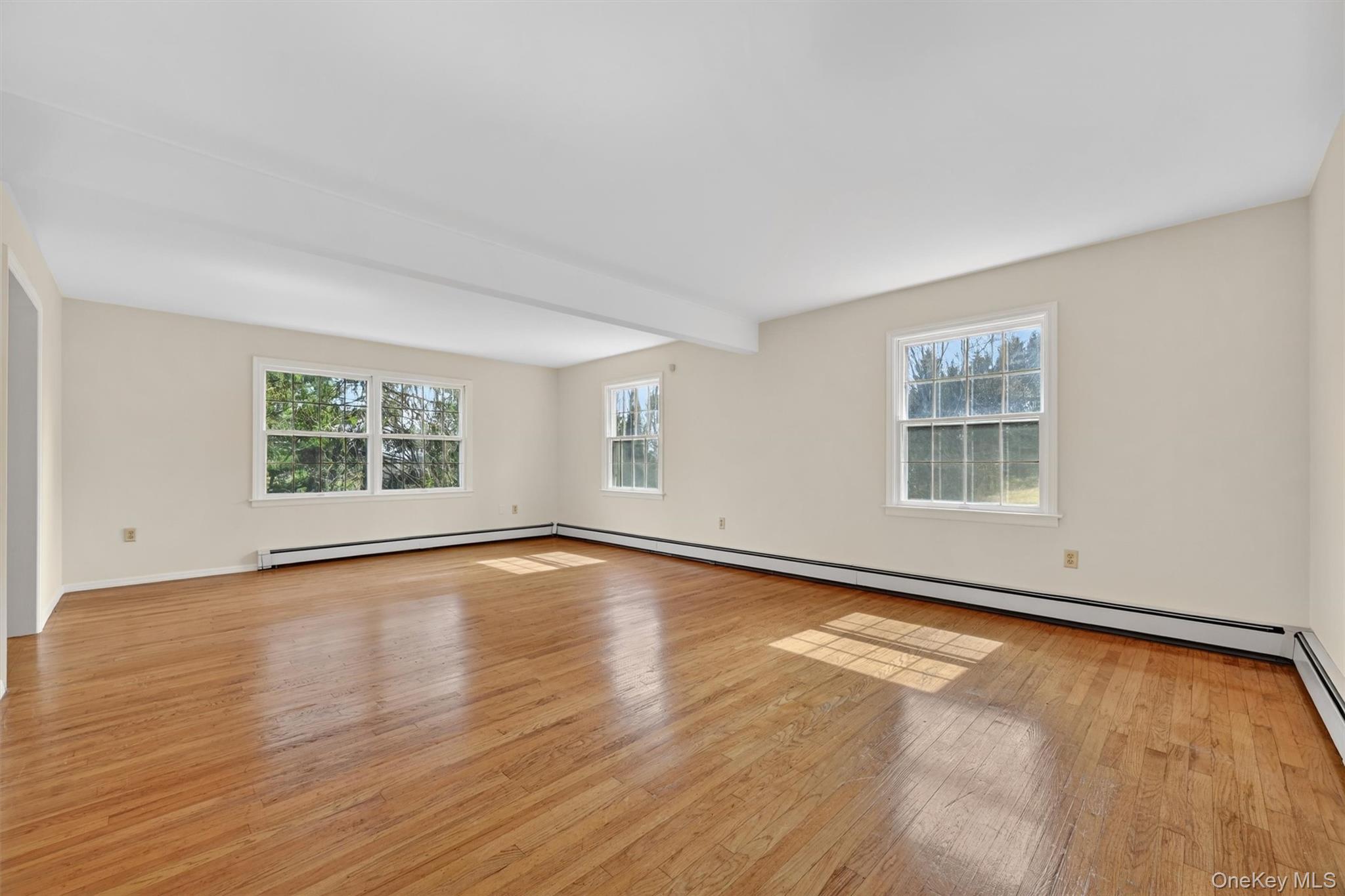 47 Still Road Westtown, NY 10998 - Photo 8 of 49 Formal living room - actual view. This expansive room features hardwood floors, light-toned walls, and white trim.