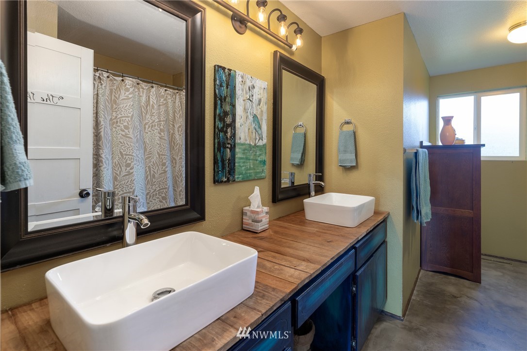 12020 Moen Road Granite Falls, WA 98252 - Photo 11 of 27 a bathroom with a granite countertop sink and a mirror