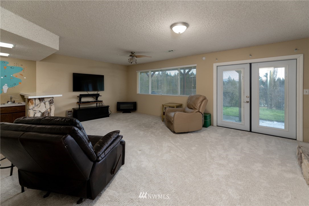 12020 Moen Road Granite Falls, WA 98252 - Photo 17 of 27 a living room with furniture and a flat screen tv
