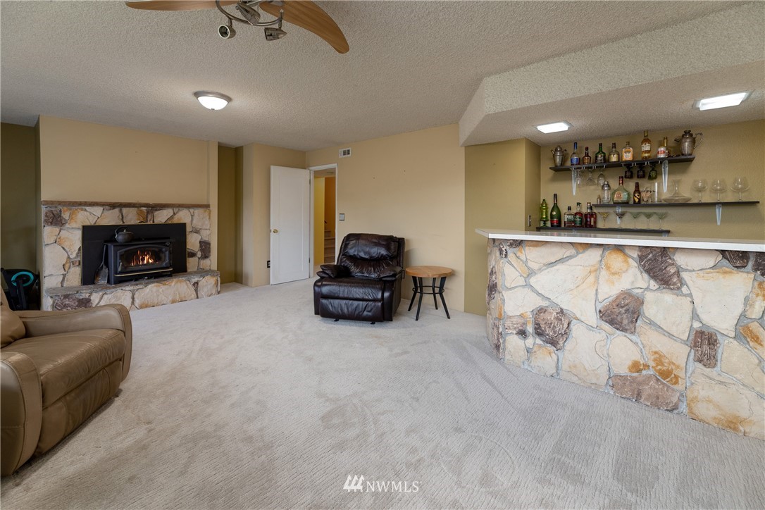 12020 Moen Road Granite Falls, WA 98252 - Photo 18 of 27 a living room with furniture and a fireplace
