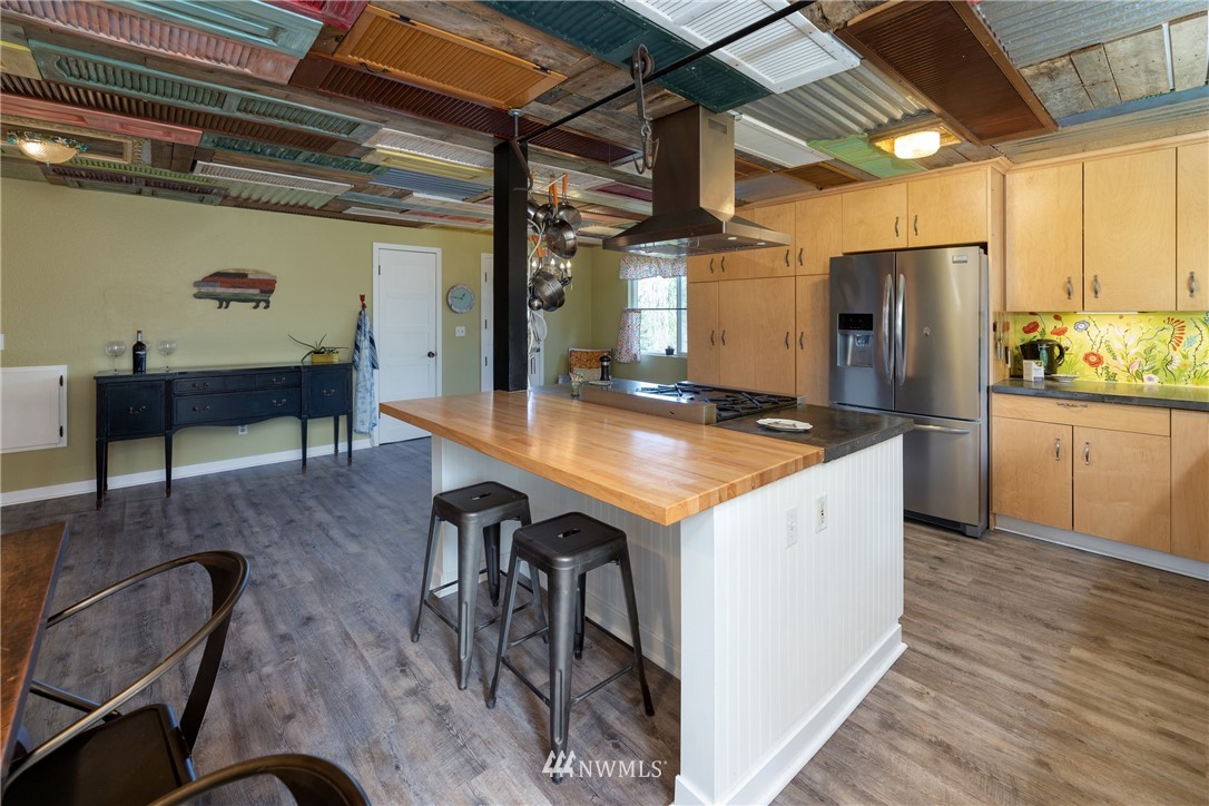 12020 Moen Road Granite Falls, WA 98252 - Photo 5 of 27 a kitchen with a table chairs refrigerator and cabinets