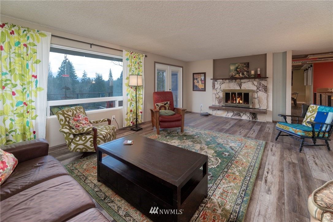 12020 Moen Road Granite Falls, WA 98252 - Photo 9 of 27 a living room with furniture rug and wooden floor