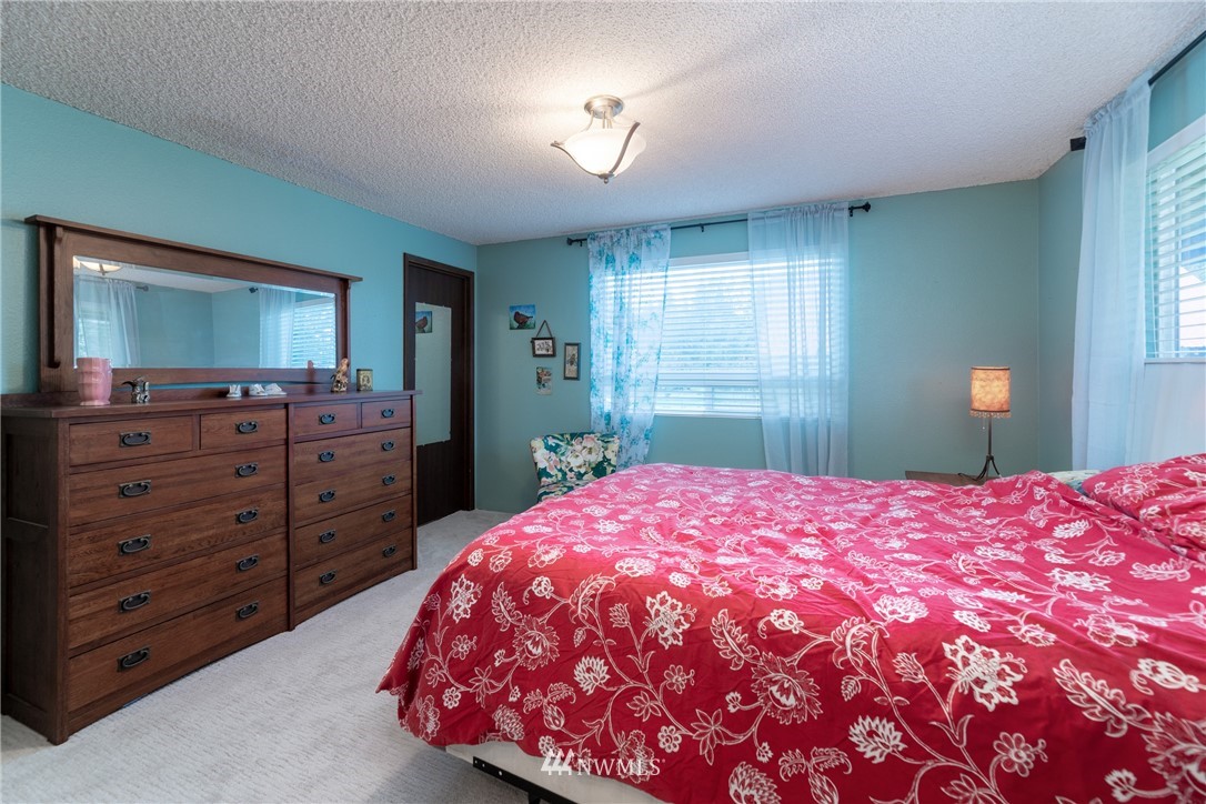 12020 Moen Road Granite Falls, WA 98252 - Photo 10 of 27 a bedroom with a bed and a dresser
