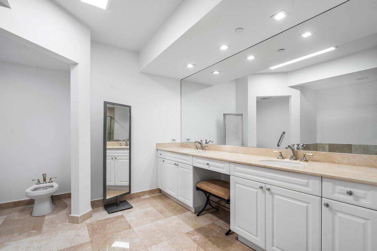 550 Southeast Mizner Boulevard, Unit B706 Boca Raton, FL 33432 - Photo 13 of 64 a spacious bathroom with a granite countertop sink a toilet and a mirror