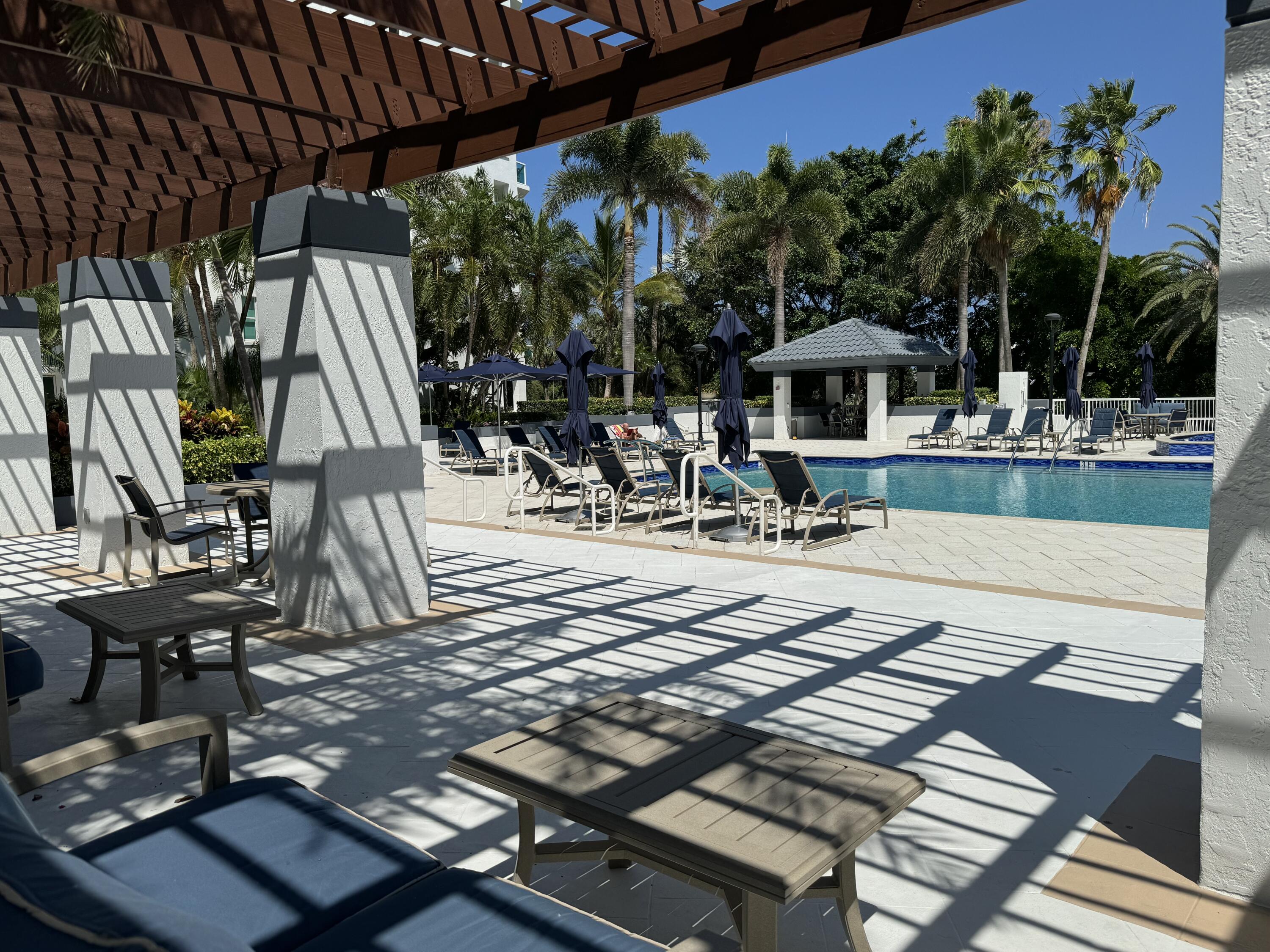 550 Southeast Mizner Boulevard, Unit B706 Boca Raton, FL 33432 - Photo 40 of 64 a view of a patio with table and chairs and potted plants