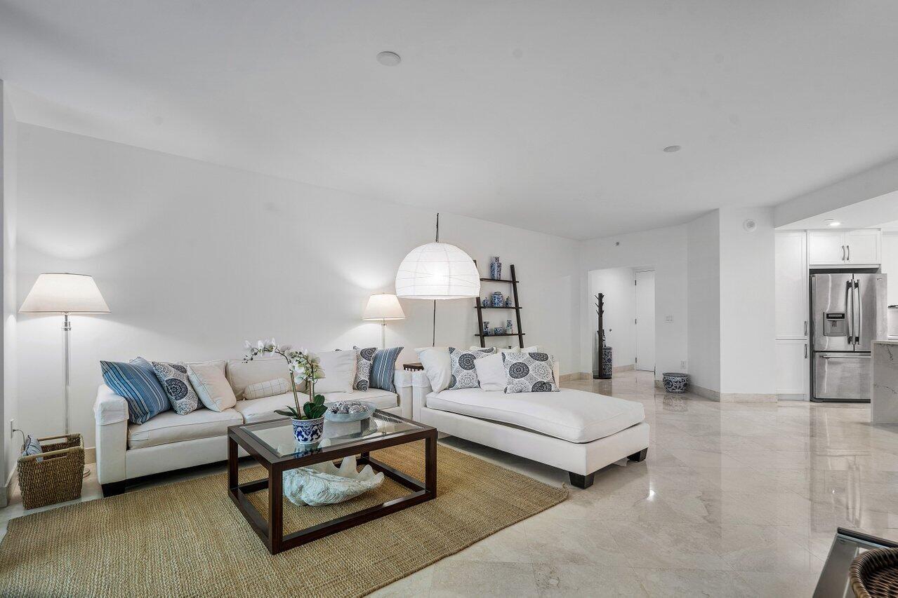 550 Southeast Mizner Boulevard, Unit B706 Boca Raton, FL 33432 - Photo 4 of 64 a living room with furniture a lamp and a potted plant