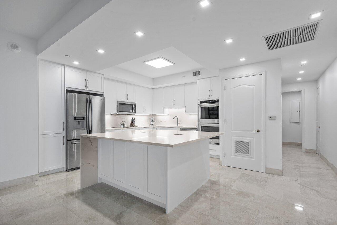 550 Southeast Mizner Boulevard, Unit B706 Boca Raton, FL 33432 - Photo 6 of 64 a kitchen with kitchen island cabinets and refrigerator