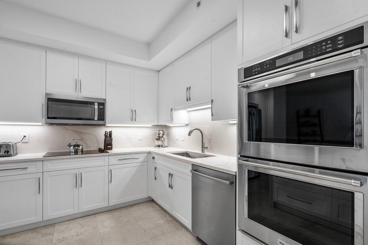 550 Southeast Mizner Boulevard, Unit B706 Boca Raton, FL 33432 - Photo 8 of 64 a kitchen with cabinets stainless steel appliances and sink