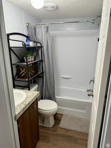 275 North Main Street, Unit 31 Centerfield, UT 84622 - Photo 9 of 13 Full bathroom with vanity, dark wood-style floors, a textured ceiling, and shower / bath combo