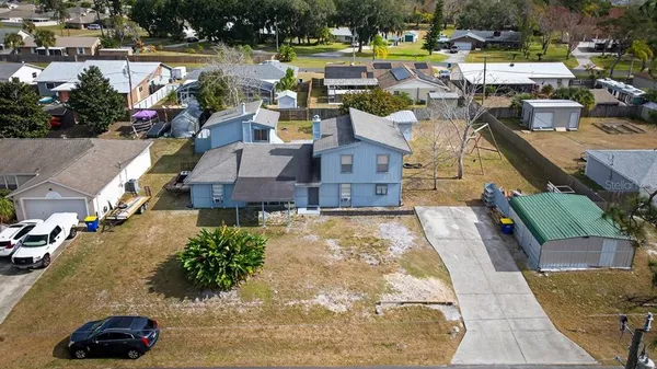 an aerial view of a houses with yard