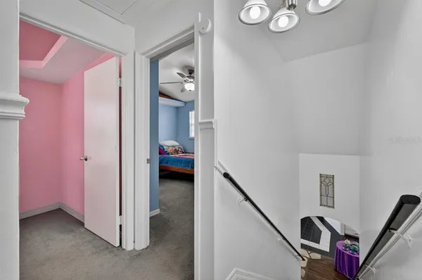 a room with a bed and a chandelier