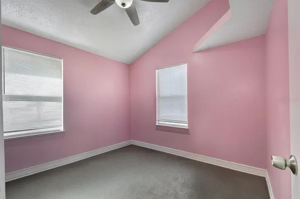 a bedroom with a bed and a ceiling fan