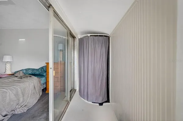 a bedroom with bed and walk in closet