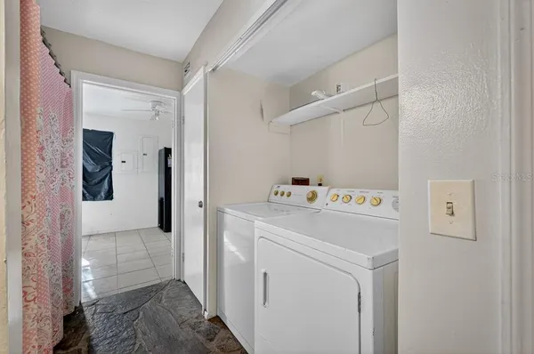 a bathroom with a granite countertop shower curtain and a sink